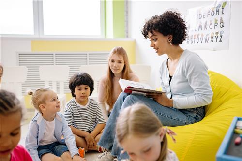 teacher reading to young students